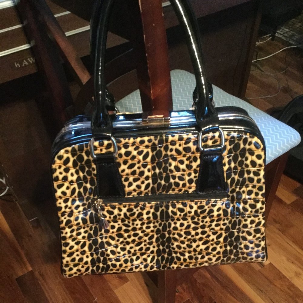 Patient leather type fabric sturdy construction animal print hand/shoulder bag